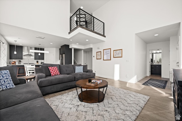 4513 S Bleecker Pl E, Millcreek, UT 84117 - living room featuring a towering ceiling and light wood-type flooring
