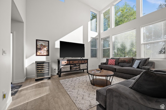 4513 S Bleecker Pl E, Millcreek, UT 84117 - living room with wine cooler, light hardwood / wood-style floors, and a high ceiling