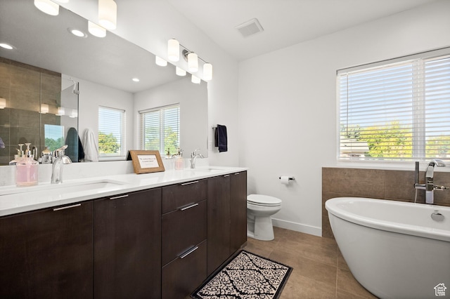 4513 S Bleecker Pl E, Millcreek, UT 84117 - bathroom featuring tile patterned flooring, vanity, a washtub, and toilet