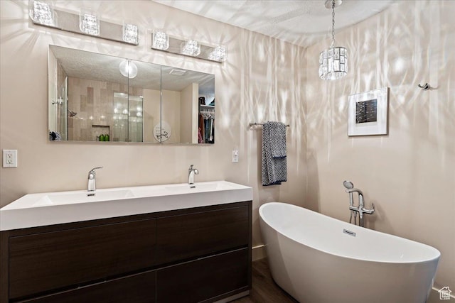 bathroom with vanity and a tub