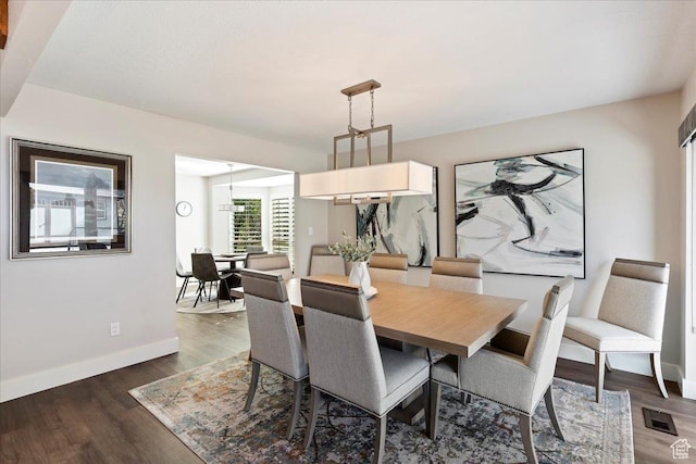 dining space with dark hardwood / wood-style floors
