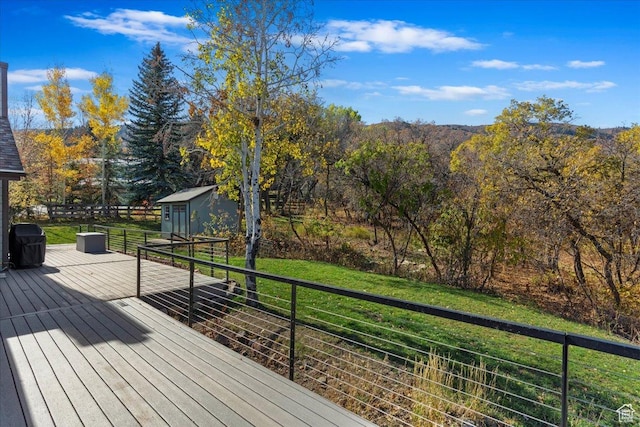 deck featuring a yard and grilling area