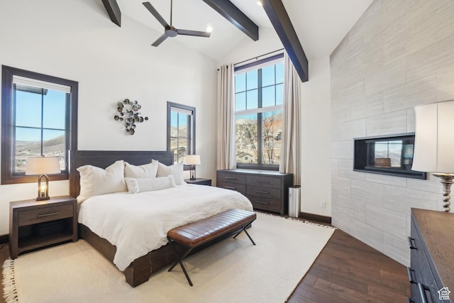 10725 N Hideout Trl, Hideout, UT 84036 - bedroom featuring high vaulted ceiling, dark wood finished floors, beamed ceiling, tile walls, and a tile fireplace