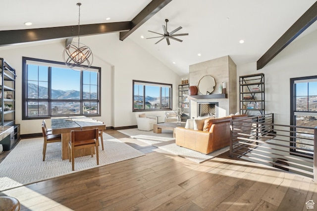10725 N Hideout Trl, Hideout, UT 84036 - living area featuring beam ceiling, hardwood / wood-style floors, a large fireplace, a ceiling fan, and high vaulted ceiling