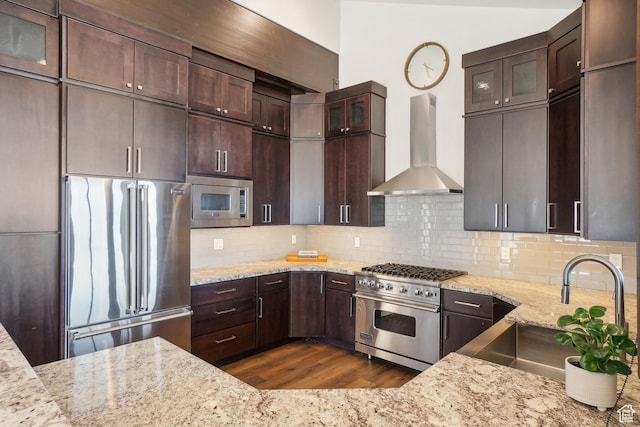 10725 N Hideout Trl, Hideout, UT 84036 - kitchen with high end appliances, wall chimney exhaust hood, dark wood-type flooring, light stone counters, and dark brown cabinets