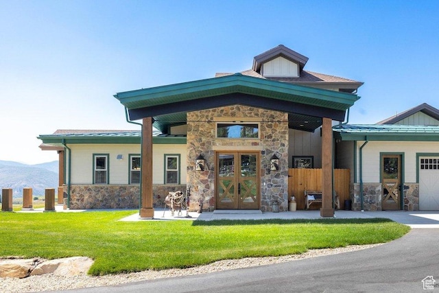 6117 Rocky Ridge Rd N, Peoa, UT 84061 - view of front facade with french doors, a mountain view, and a front lawn