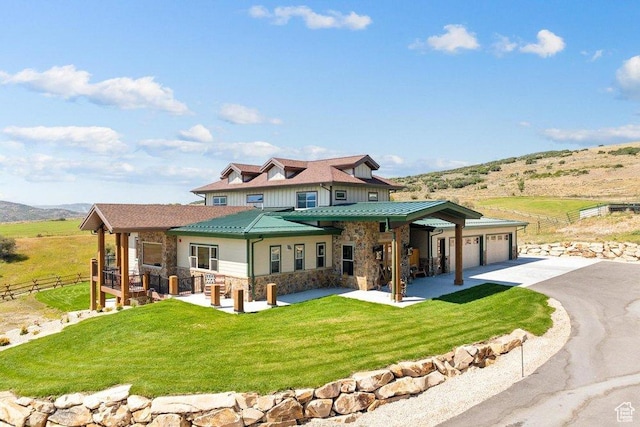 6117 Rocky Ridge Rd N, Peoa, UT 84061 - rear view of property with a garage, a mountain view, and a lawn