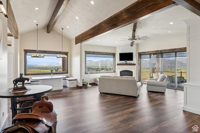 6117 Rocky Ridge Rd N, Peoa, UT 84061 - living room featuring high vaulted ceiling, dark hardwood / wood-style floors, ceiling fan with notable chandelier, and beam ceiling