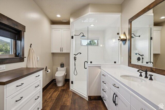 6117 Rocky Ridge Rd N, Peoa, UT 84061 - bathroom with hardwood / wood-style flooring, toilet, an enclosed shower, and a wealth of natural light