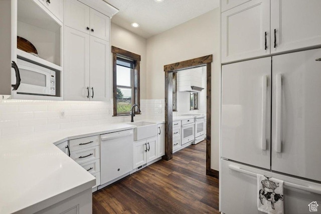 6117 Rocky Ridge Rd N, Peoa, UT 84061 - kitchen featuring white cabinetry, sink, dark hardwood / wood-style flooring, decorative backsplash, and white appliances