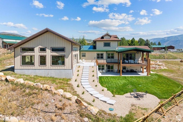 6117 Rocky Ridge Rd N, Peoa, UT 84061 - rear view of property featuring a patio, a yard, and a deck with mountain view