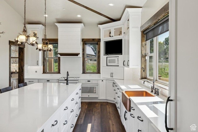 6117 Rocky Ridge Rd N, Peoa, UT 84061 - kitchen featuring dark hardwood / wood-style floors, pendant lighting, tasteful backsplash, white cabinetry, and white appliances