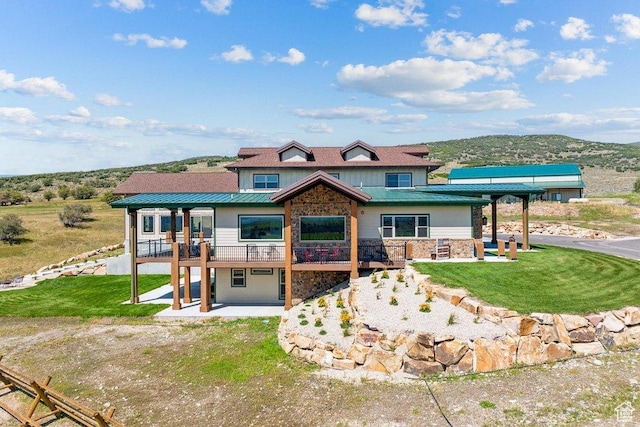 6117 Rocky Ridge Rd N, Peoa, UT 84061 - view of front of house featuring a patio, a deck, and a front lawn