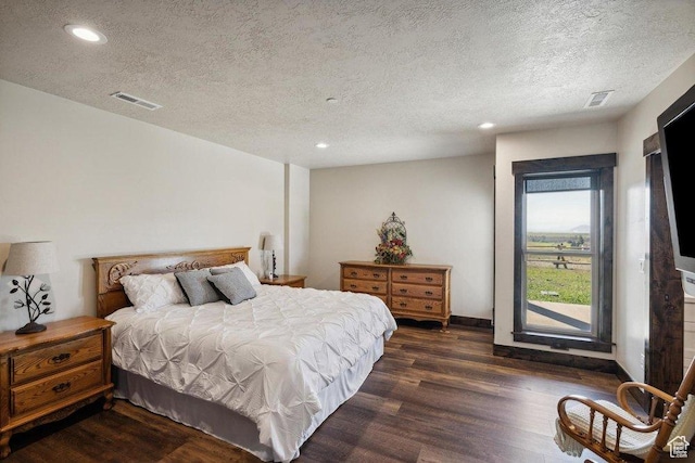 6117 Rocky Ridge Rd N, Peoa, UT 84061 - bedroom with dark hardwood / wood-style flooring and a textured ceiling
