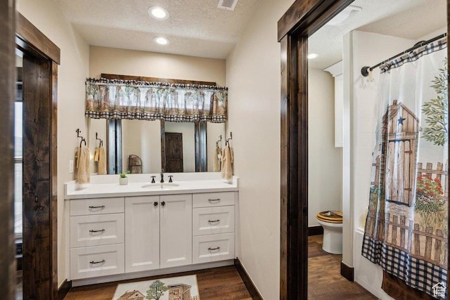 6117 Rocky Ridge Rd N, Peoa, UT 84061 - bathroom with toilet, a shower with curtain, wood-type flooring, a textured ceiling, and vanity