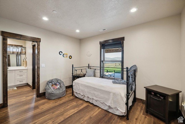 6117 Rocky Ridge Rd N, Peoa, UT 84061 - bedroom featuring dark hardwood / wood-style floors and a textured ceiling