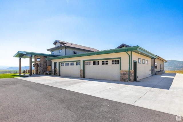 6117 Rocky Ridge Rd N, Peoa, UT 84061 - view of front of property featuring a garage and a mountain view