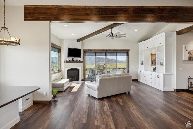6117 Rocky Ridge Rd N, Peoa, UT 84061 - living room with dark wood-type flooring, ceiling fan with notable chandelier, and vaulted ceiling with beams