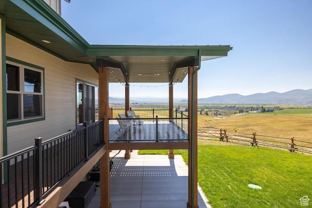 6117 Rocky Ridge Rd N, Peoa, UT 84061 - wooden deck with a rural view, a mountain view, a yard, and a patio area