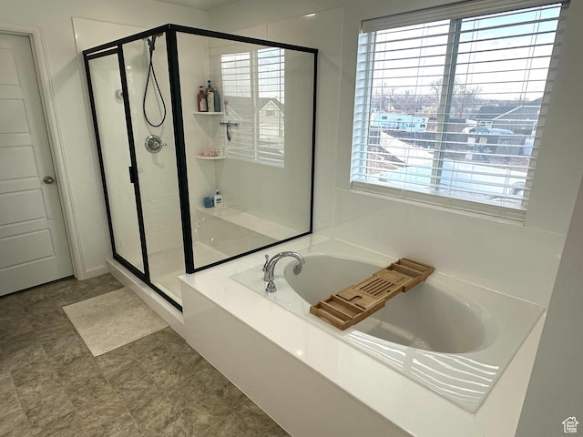 bathroom with shower with separate bathtub