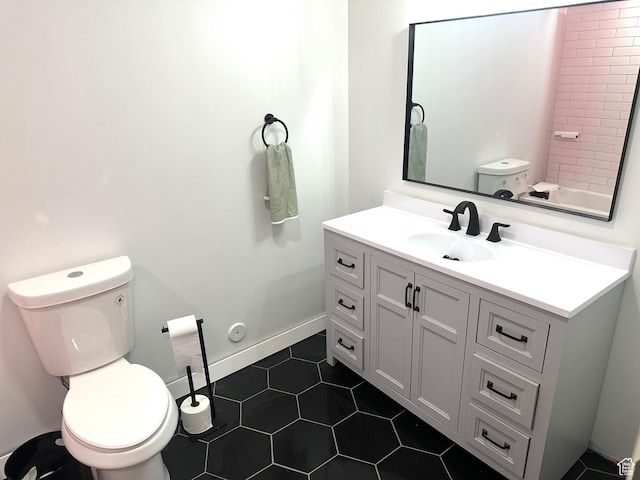 bathroom featuring vanity, tile patterned floors, and toilet