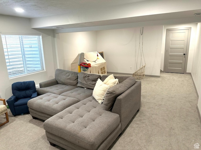 living room featuring light carpet and a textured ceiling
