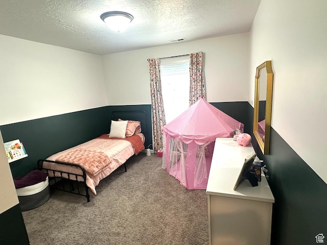 carpeted bedroom featuring a textured ceiling