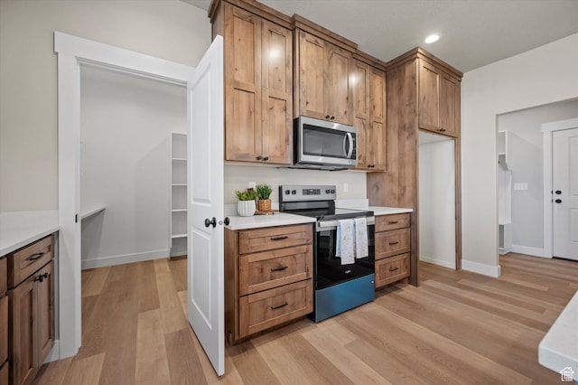 831 E 490 N Unit 143, Hyde Park, UT 84318 - kitchen featuring light hardwood / wood-style floors and appliances with stainless steel finishes