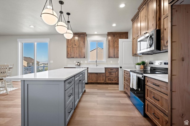 831 E 490 N Unit 143, Hyde Park, UT 84318 - kitchen with sink, gray cabinetry, hanging light fixtures, a kitchen island, and stainless steel appliances