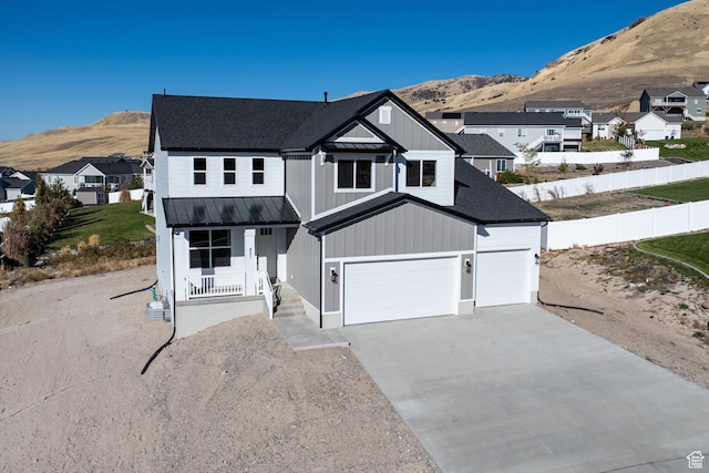 view of front of house with a mountain view, a garage, and covered porch
