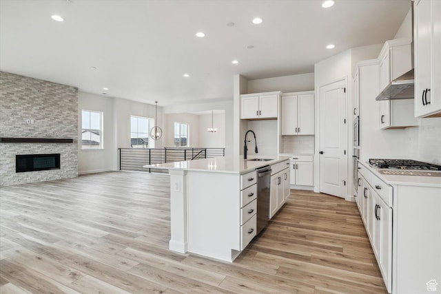6199 W Wapiti Ridge Ln Unit 333, Herriman, UT 84096 - kitchen with white cabinetry, appliances with stainless steel finishes, sink, and a kitchen island with sink