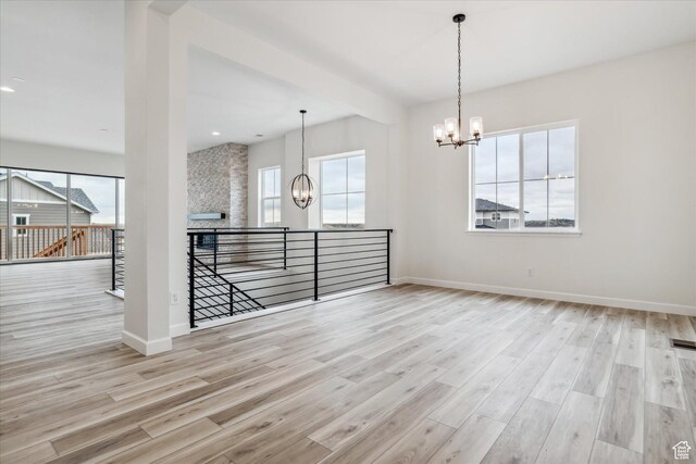 6199 W Wapiti Ridge Ln Unit 333, Herriman, UT 84096 - empty room featuring an inviting chandelier and light hardwood / wood-style floors