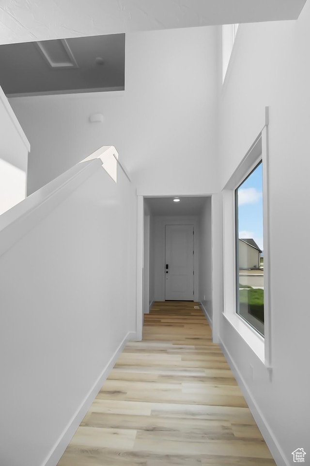 3463 W 3175 N Unit 362, Plain City, UT 84404 - hallway featuring a towering ceiling and light hardwood / wood-style floors