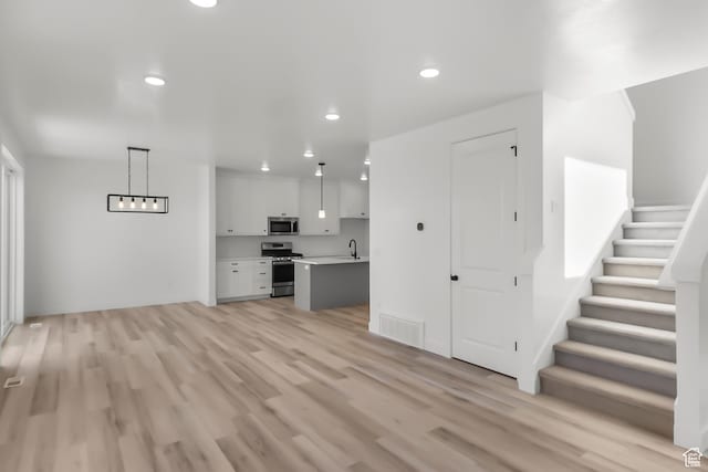3463 W 3175 N Unit 362, Plain City, UT 84404 - unfurnished living room featuring sink and light hardwood / wood-style floors