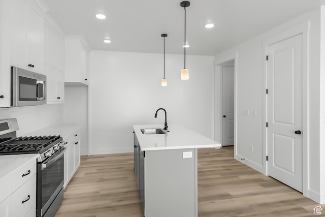 3463 W 3175 N Unit 362, Plain City, UT 84404 - kitchen with sink, white cabinetry, pendant lighting, stainless steel appliances, and a kitchen island with sink
