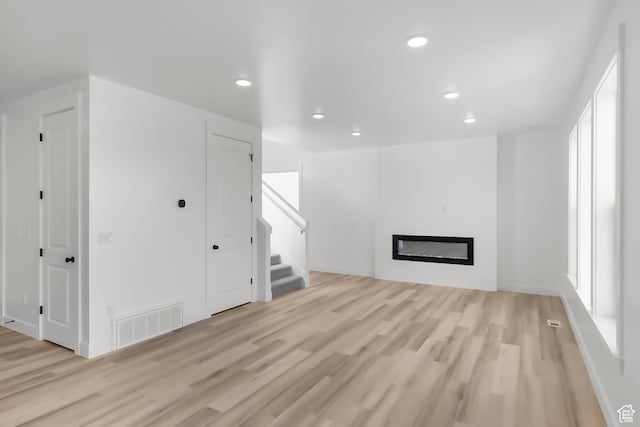 3463 W 3175 N Unit 362, Plain City, UT 84404 - unfurnished living room with a fireplace and light hardwood / wood-style flooring