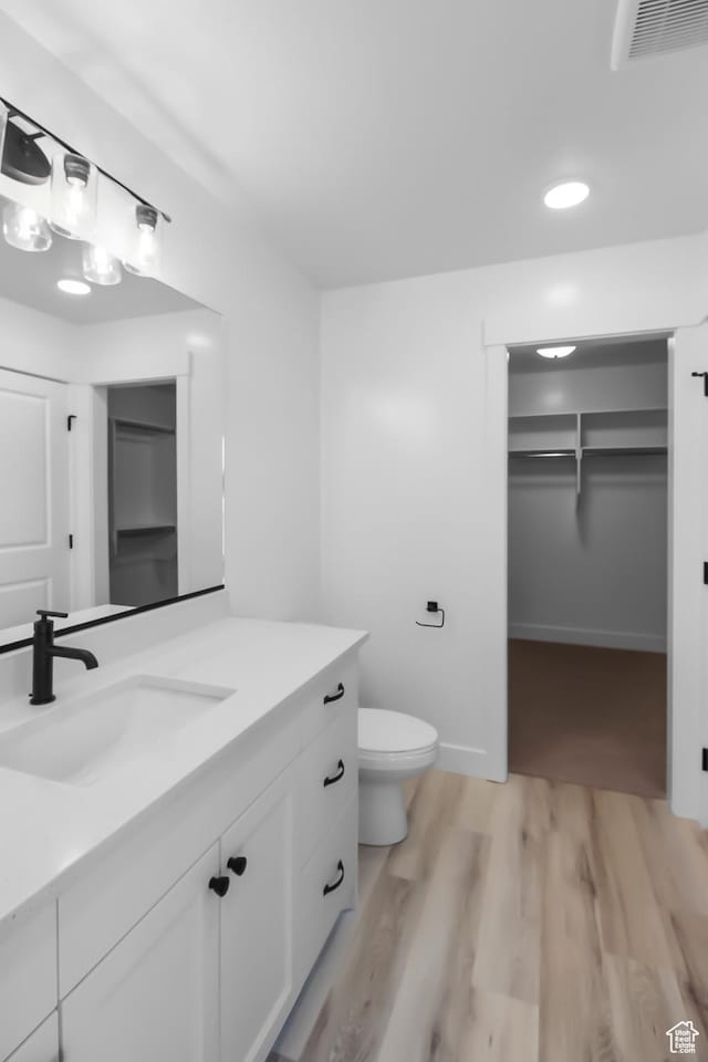 3463 W 3175 N Unit 362, Plain City, UT 84404 - bathroom featuring vanity, hardwood / wood-style floors, and toilet