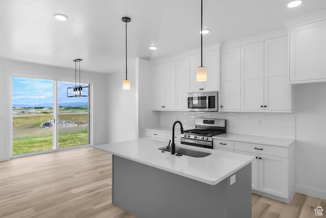 3463 W 3175 N Unit 362, Plain City, UT 84404 - kitchen with stainless steel appliances, sink, hanging light fixtures, and white cabinets
