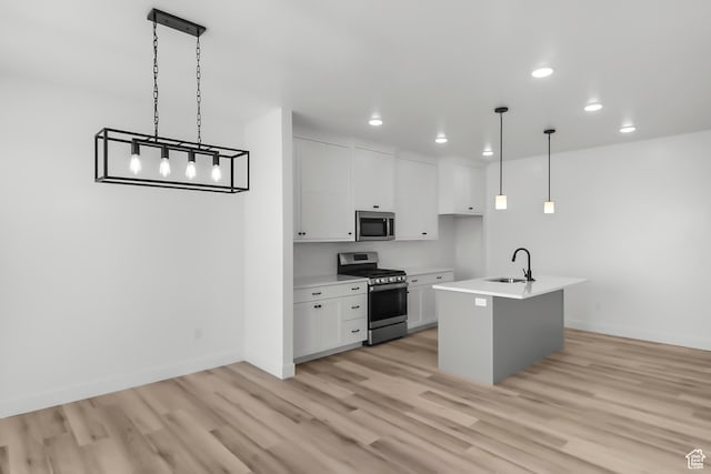 3463 W 3175 N Unit 362, Plain City, UT 84404 - kitchen featuring sink, decorative light fixtures, stainless steel appliances, a kitchen island with sink, and white cabinets