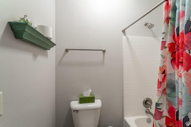 bathroom with shower / bath combo and toilet