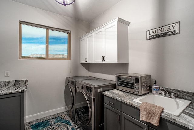 laundry area featuring cabinet space, washer and clothes dryer, and baseboards
