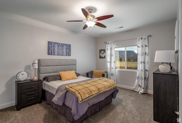 carpeted bedroom featuring baseboards and a ceiling fan