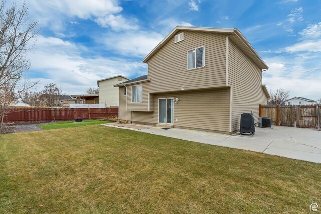 502 N Hidden Cv E, Ogden, UT 84404 - rear view of property with a yard, central AC, and a patio area
