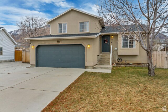split level home featuring a garage and a front yard