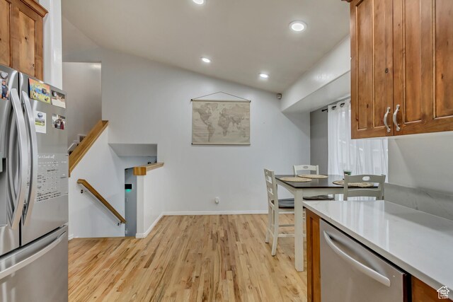 502 N Hidden Cv E, Ogden, UT 84404 - kitchen featuring vaulted ceiling, light hardwood / wood-style floors, and appliances with stainless steel finishes