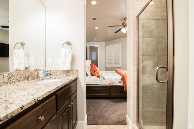 bathroom featuring vanity, a shower with door, and ceiling fan