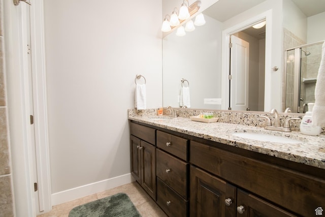 bathroom featuring vanity, tile patterned floors, and a shower with shower door