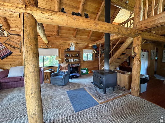 1554 Ireland Ln E, Brian Head, UT 84719 - carpeted living room with wooden ceiling, wooden walls, lofted ceiling with beams, and a wood stove