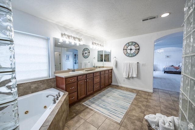 1903 W Wild Wood Ct N, Lehi, UT 84043 - bathroom with tile patterned floors, vanity, a textured ceiling, and tiled tub