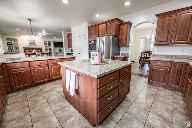 1903 W Wild Wood Ct N, Lehi, UT 84043 - kitchen with light tile patterned floors, appliances with stainless steel finishes, a kitchen island, a notable chandelier, and pendant lighting